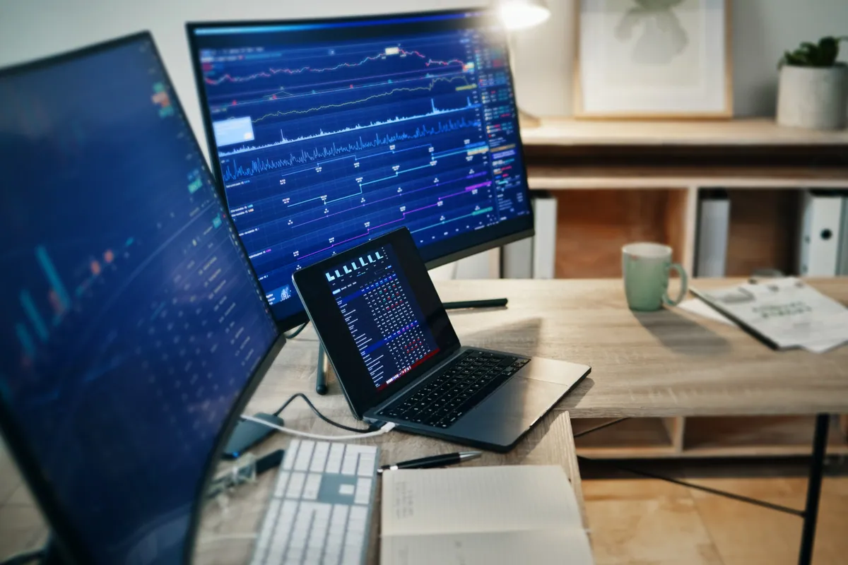 A desk workstation running dual monitors from a single docked laptop