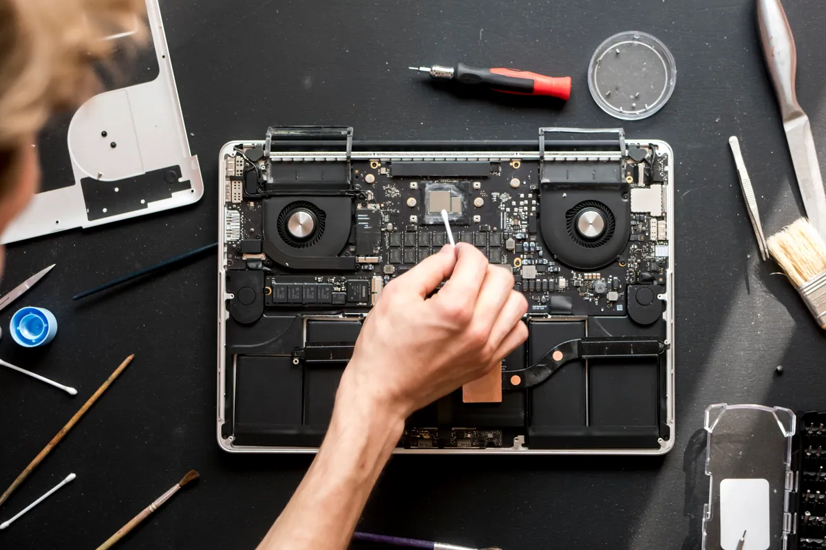 Overhead view of a technician working on a laptop